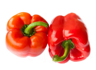 Two red peppers, isolated on white background