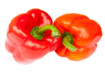 Two red peppers, isolated on white background