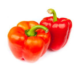 Two red peppers, isolated on white background