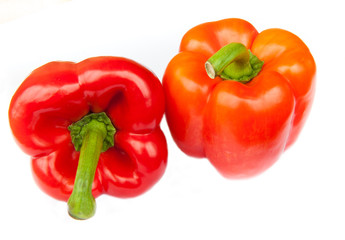 Two red peppers, isolated on white background