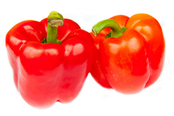 Two red peppers, isolated on white background