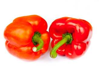 Two red peppers, isolated on white background