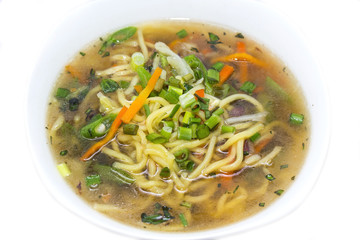 soup with meat and pasta on a white background in the restaurant