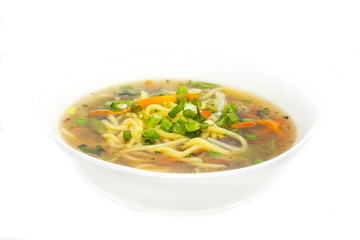 soup with meat and pasta on a white background in the restaurant
