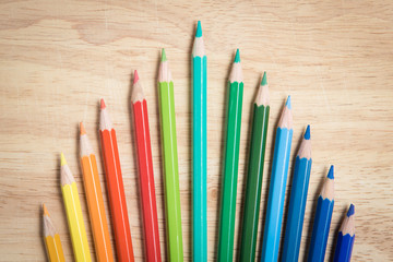 multiple pencil color arrang as a crown on the wood block