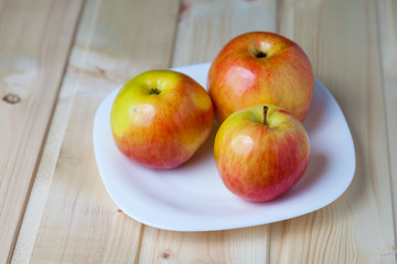 Apples in a bowl on a wooden table