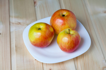 Apples in a bowl on a wooden table