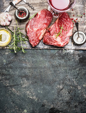 Two raw fillet steaks for grill,BBQ or frying with herbs and spices on rustic background, top view, place for text. Meat food. Argentinian steak