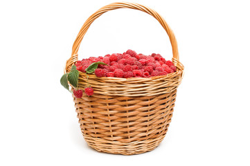 Fototapeta na wymiar Fresh ripe red raspberries in a wicker bowl