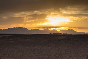 Sunset behind the mountains in the desert, Egypt