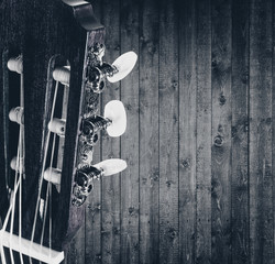 fragment of acoustic guitar. Processing in vintage style on wooden background