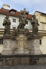 Fototapeta na wymiar Statue of the Holy Savior with Cosmas and Damian at Charles Bridge in Prague