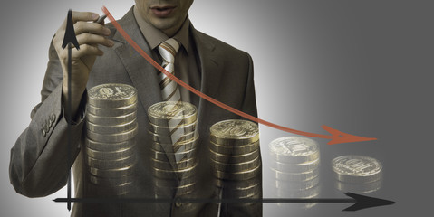 business concept. businessman drawing a graph down with coins