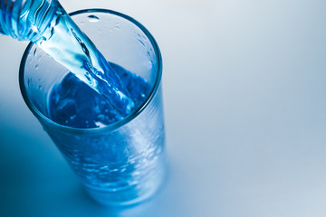 Pour cold water into glass