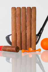 Golf driver and different cigars on a glass desk