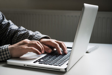 hands on laptop keyboard