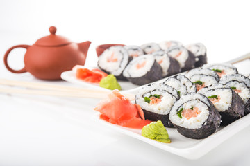 Sushi rolls with salmon and green tea