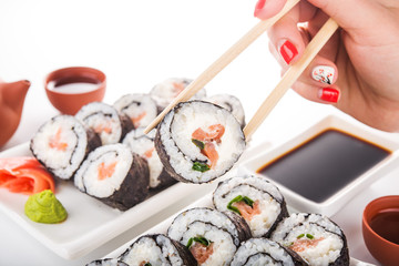 Woman hold sushi roll