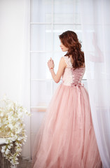 Bride in a pink dress with flowers
