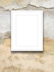 Close-up of one white picture frame on weathered wall background