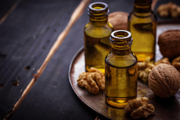 Fototapeta na wymiar Walnuts oil in small bottles