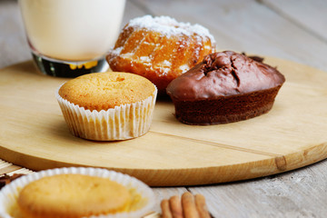 Muffins and milk on the wooden table