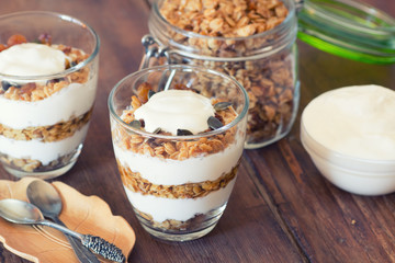 Healthy Breakfast - yogurt with homemade granola on the bright wooden board