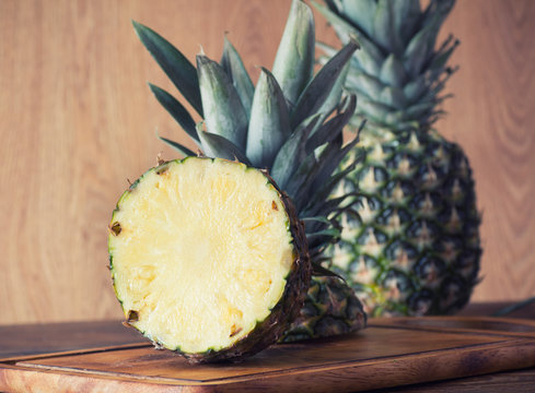 Pineapple fruit cut on wooden plate