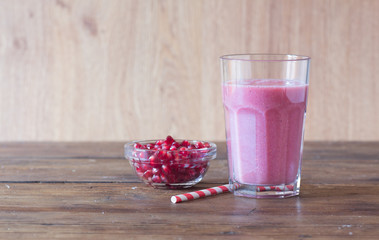 pomegranate smoothie on wooden background