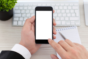 Businessman hands holding phone with isolated screen in the offi