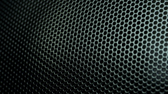 Dark metal background with perforated holes. 4K 3840x2160 UHD video.
