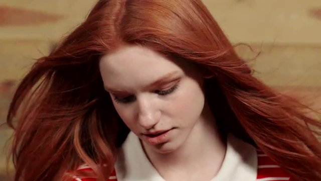 Beautiful redhead girl showing different emotions. Slow motion. Close up.