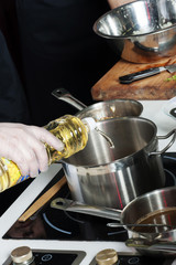 Pans in the kitchen, the cook hands.