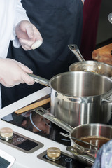 Pans in the kitchen, the cook hands.
