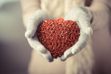 Fototapeta premium Female hands in mitten with heart