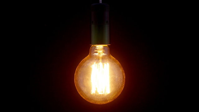 Real Edison light bulb flickering. Vintage filament Edison light bulb.
