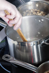 Pans in the kitchen, the cook hands.