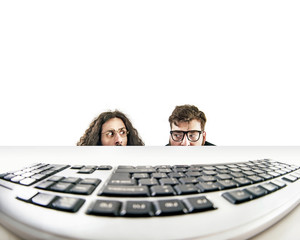 Two nerds staring at a keyboard - obrazy, fototapety, plakaty