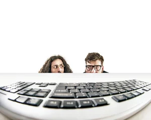 Zelfklevend Fotobehang Two nerds staring at a keyboard © konradbak