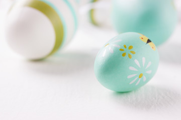 Colorful Easter eggs on a bright background, closeup, selective focus.