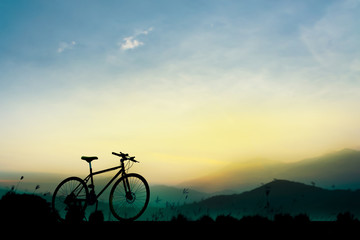 Obraz premium Sunset silhouette and bicycle on beautiful sky