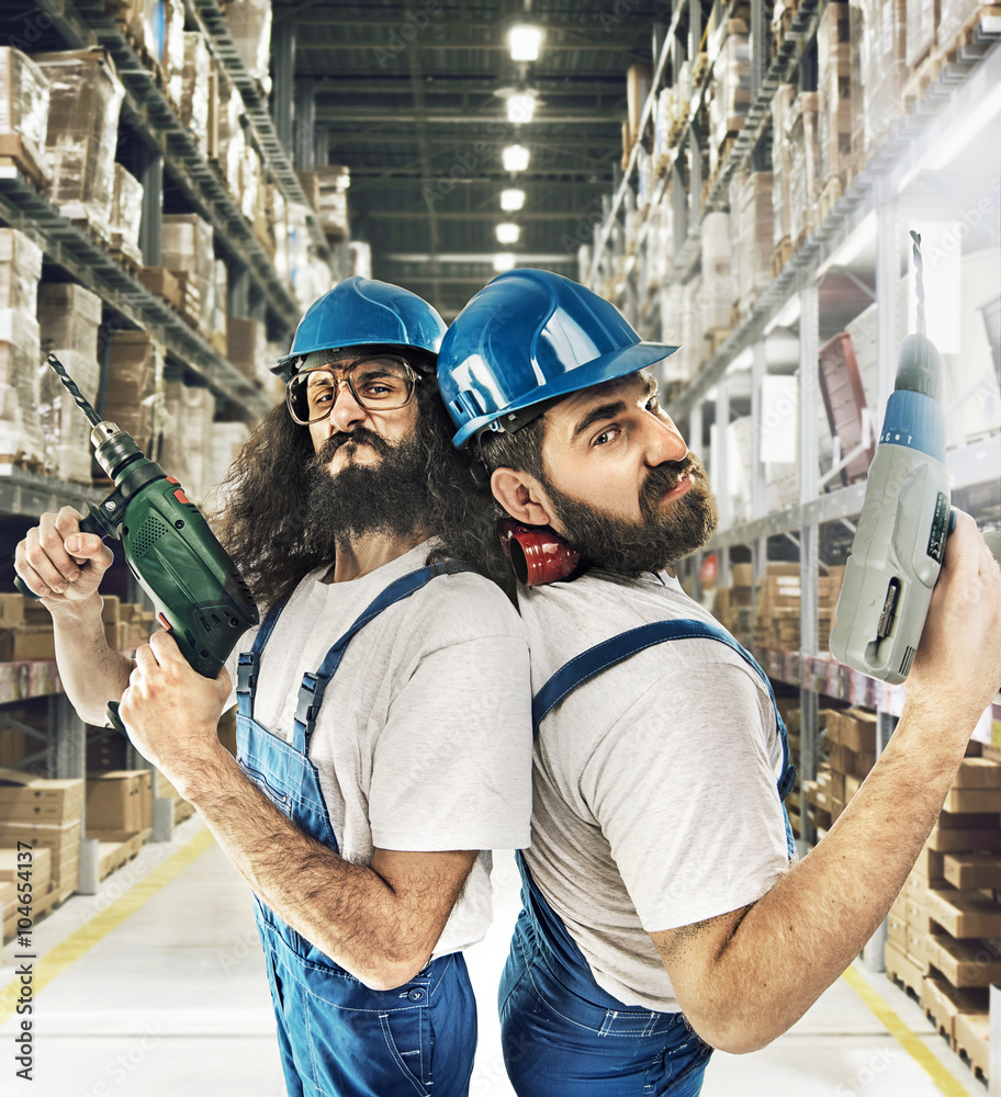 Wall mural Portrait of two builders in a storehouse