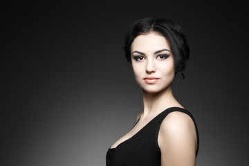 Portrait of beautiful female model on gray background