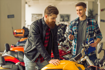 Fototapeta na wymiar Men in motorbike salon