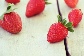 Fresh red strawberries on old wooden background