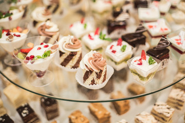Different delicious desserts and cakes on the buffet table