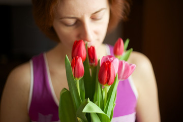 Bunch of tulips in woman hands.