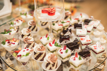 Different delicious desserts and cakes on the buffet table
