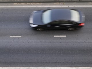 Blur black car on the road from top view