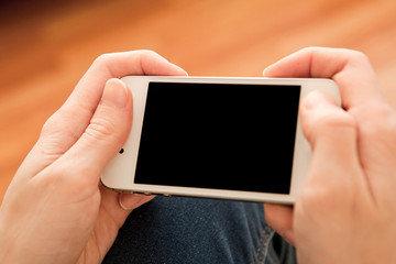 Woman using her smartphone inside